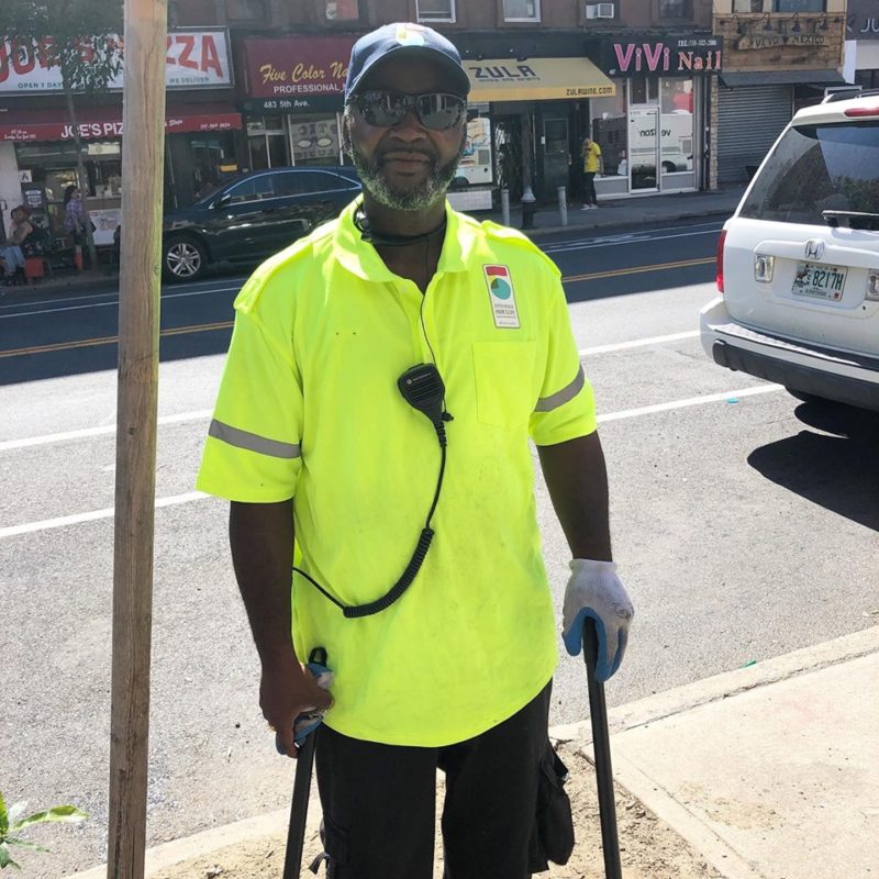 A friendly sanitation worker helps keep #theother5th clean